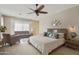 Main bedroom with king bed and sitting area at 8689 E Windrose Dr, Scottsdale, AZ 85260