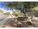 Astoria community entrance with a stone sign and landscaping at 8689 E Windrose Dr, Scottsdale, AZ 85260