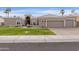 Beautiful two-story home with a three-car garage and manicured lawn at 8689 E Windrose Dr, Scottsdale, AZ 85260