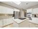 Modern kitchen with granite counters and breakfast bar at 8689 E Windrose Dr, Scottsdale, AZ 85260