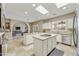Bright kitchen with large island, stainless steel appliances, and a view of the Gathering room at 8689 E Windrose Dr, Scottsdale, AZ 85260