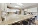 Large kitchen with granite counters and breakfast bar at 8689 E Windrose Dr, Scottsdale, AZ 85260