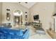 Spacious living room with a fireplace, large TV, and comfortable seating at 8689 E Windrose Dr, Scottsdale, AZ 85260
