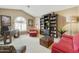 Home office with red sofa, bookshelves, and a workspace at 8689 E Windrose Dr, Scottsdale, AZ 85260