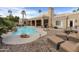 Inviting kidney-shaped pool with surrounding patio and lounge chairs at 8689 E Windrose Dr, Scottsdale, AZ 85260