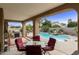 Inviting pool area with patio furniture, lush landscaping, and a water feature at 8689 E Windrose Dr, Scottsdale, AZ 85260