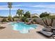 Relaxing swimming pool with lounge chairs and palm trees at 8689 E Windrose Dr, Scottsdale, AZ 85260