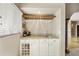Wet bar with granite countertop, wine rack, and glass storage at 8689 E Windrose Dr, Scottsdale, AZ 85260