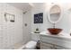 Modern bathroom with a white subway tile shower and unique sink at 1014 E Michigan Ave, Phoenix, AZ 85022