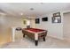 Upstairs game room with pool table and sports decor at 16478 W Culver St, Goodyear, AZ 85338