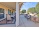 Covered patio with seating area, dining table, and landscaping at 16824 W Palisade Trail Ln, Surprise, AZ 85387