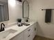 Stylish bathroom with double vanity, modern fixtures, and a sleek mirror at 1745 E Glade Ave, Mesa, AZ 85204