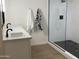 Modern bathroom with double vanity, quartz countertop and a large shower at 1745 E Glade Ave, Mesa, AZ 85204