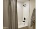 Clean bathroom with tub shower combination and updated fixtures at 1745 E Glade Ave, Mesa, AZ 85204