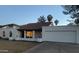 White single story home with a red tile roof, two-car garage, and landscaping at 1745 E Glade Ave, Mesa, AZ 85204