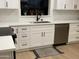 Modern kitchen with white shaker cabinets, quartz countertops, and stainless steel appliances at 1745 E Glade Ave, Mesa, AZ 85204