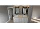 Updated bathroom with double vanity, modern fixtures, and large mirrors at 17913 W Desert View Ln, Goodyear, AZ 85338