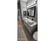 Modern bathroom with double vanity, updated fixtures, and gray walls at 17913 W Desert View Ln, Goodyear, AZ 85338