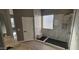Modern bathroom with walk-in shower, marble tile, and double sinks at 17913 W Desert View Ln, Goodyear, AZ 85338