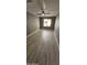 Large bedroom with wood-look floors and window at 17913 W Desert View Ln, Goodyear, AZ 85338