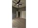 Bright bedroom featuring wood-look floors and double doors at 17913 W Desert View Ln, Goodyear, AZ 85338