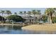 Community center situated by a lake with palm trees at 17913 W Desert View Ln, Goodyear, AZ 85338