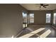 Bright Gathering room with sliding glass doors and wood-look flooring at 17913 W Desert View Ln, Goodyear, AZ 85338