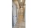 Light-filled hallway with wood-look floors and multiple doors at 17913 W Desert View Ln, Goodyear, AZ 85338