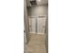 Hallway with light walls, wood-look floors, and two doors at 17913 W Desert View Ln, Goodyear, AZ 85338