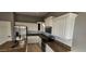 Modern kitchen featuring white cabinets and granite countertops at 17913 W Desert View Ln, Goodyear, AZ 85338