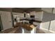 Updated kitchen with white cabinets, granite countertops and island at 17913 W Desert View Ln, Goodyear, AZ 85338