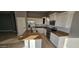 Bright kitchen with white cabinets, granite counters, and stainless steel appliances at 17913 W Desert View Ln, Goodyear, AZ 85338