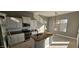 Modern kitchen with white cabinets, granite countertops, and island at 17913 W Desert View Ln, Goodyear, AZ 85338