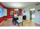 Bright dining room with red walls, tile floor, and modern chandelier at 20 E Tam Oshanter Dr, Phoenix, AZ 85022