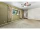 Living room with large window, ceiling fan and neutral decor at 24007 S Lindsay Rd, Chandler, AZ 85249