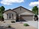 Single-story home with neutral exterior, two-car garage, and landscaping at 25401 N Selene Dr, Florence, AZ 85132