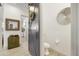 Stylish powder room with a modern pedestal sink and barn door at 30277 N 115Th Ln, Peoria, AZ 85383