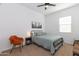 Cozy bedroom with metal bed frame and a comfortable armchair at 31617 N 123Rd Ln, Peoria, AZ 85383