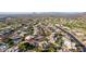 Aerial view showing a neighborhood with houses, pools, and desert landscape at 4055 N Recker Rd # 85, Mesa, AZ 85215