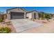 New construction home with attached garage and desert landscaping at 43632 W Yucca Ln, Maricopa, AZ 85138