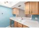 Kitchen with light blue walls, wood cabinets and modern appliances at 4439 W Solano N Dr, Glendale, AZ 85301