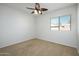 Simple bedroom with ceiling fan and window coverings at 45370 W Gavilan Dr, Maricopa, AZ 85139