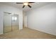 Bedroom with mirrored closet doors and ceiling fan at 45370 W Gavilan Dr, Maricopa, AZ 85139