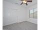 Well-lit bedroom featuring a ceiling fan and double door closet at 6344 W Tether Trail Trl, Phoenix, AZ 85083