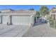 Two-car garage with a side gate and gravel landscaping at 6344 W Tether Trail Trl, Phoenix, AZ 85083