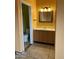 Bathroom with wood vanity and tile flooring at 771 E Pepper Dr, Casa Grande, AZ 85122