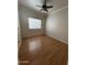 Spacious bedroom featuring light walls, wood-look flooring, and a ceiling fan at 771 E Pepper Dr, Casa Grande, AZ 85122