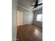 Charming bedroom with neutral walls, wood-look floors, and ceiling fan at 771 E Pepper Dr, Casa Grande, AZ 85122