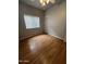 Simple bedroom with wood-look floors and a ceiling fan at 771 E Pepper Dr, Casa Grande, AZ 85122