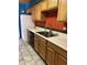 Kitchen with wood cabinets, stainless steel sink, and tile floor at 771 E Pepper Dr, Casa Grande, AZ 85122